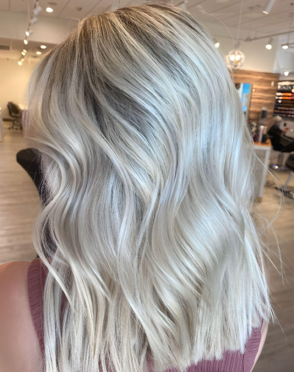 Cool-tone full babylights in San Diego featuring icy blonde highlights for a bright, seamless hair color effect.
