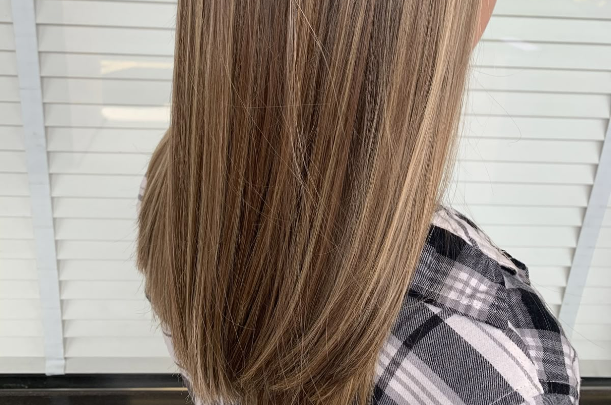 Side view of partial babylights with subtle highlights for a natural hair color blend in San Diego salon.