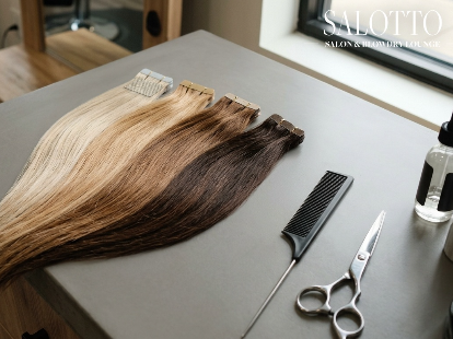 Premium tape-in hair extension wefts laid on Salotto Salon counter.